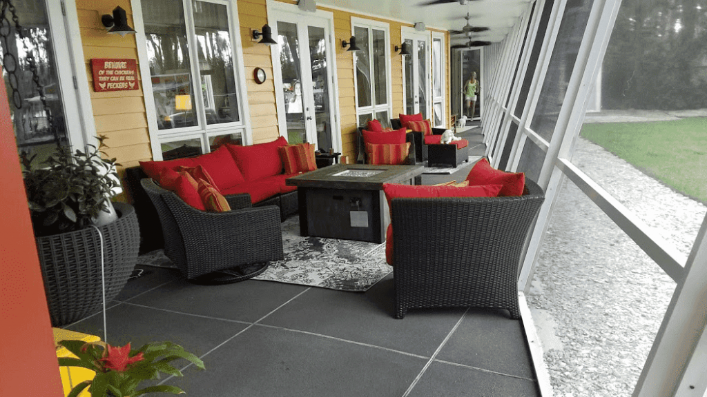 An outdoor covered patio will full furniture.