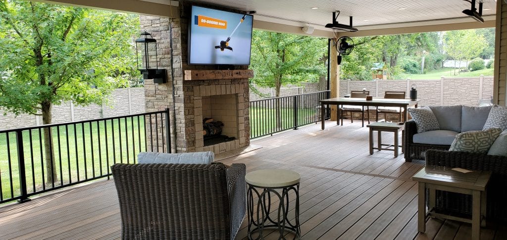 A backyard patio with a TV attached.