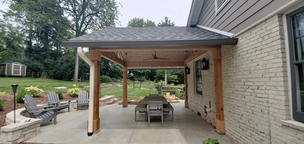 A backyard patio with an overhead roof.