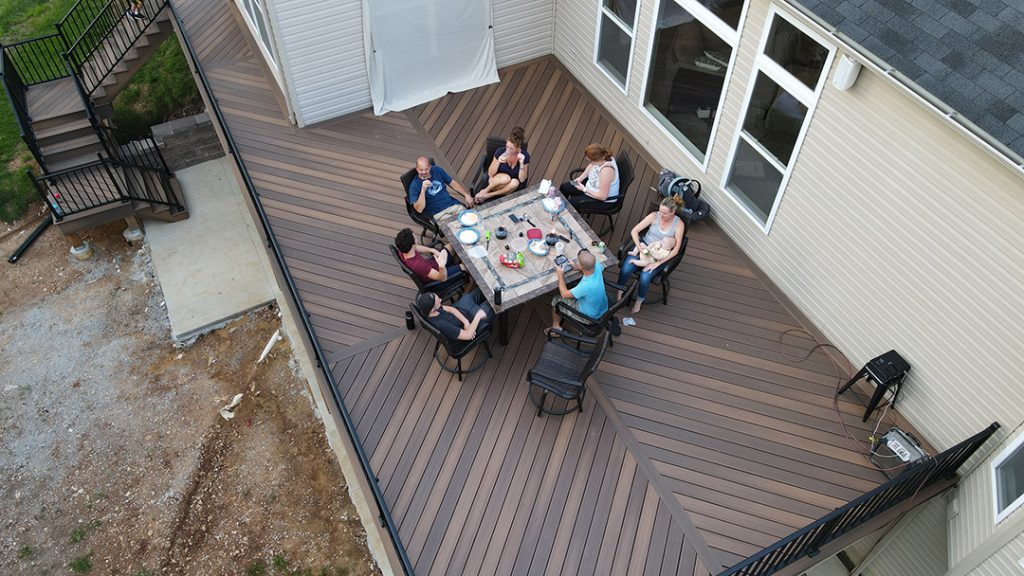 A family sitting at a table on a deck.
