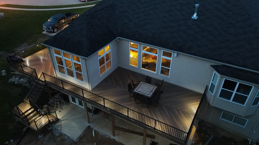 A night view of a deck with the deck lights on.